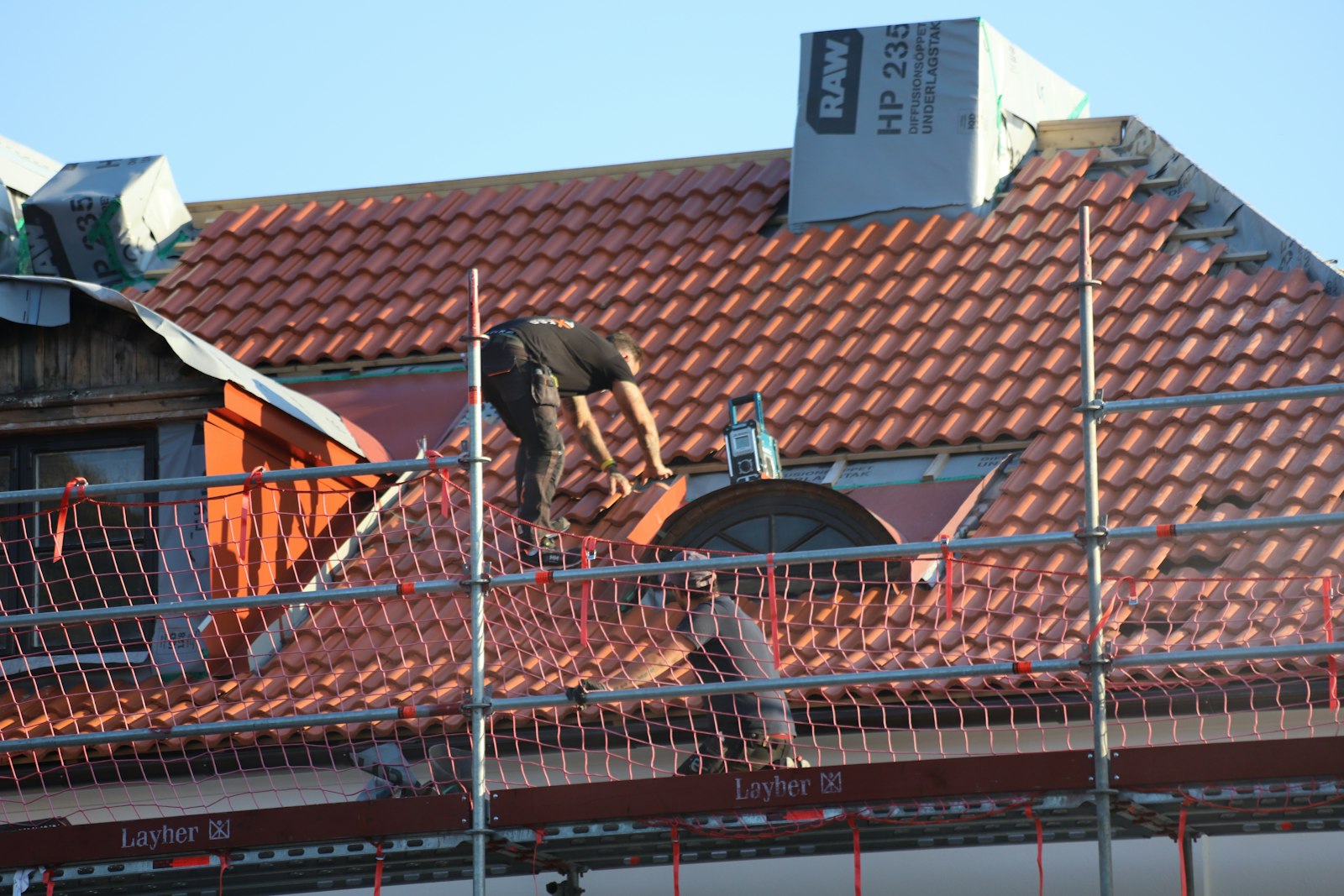 Roofer working on a residential roof slope