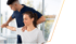 Physiotherapist assists woman with shoulder rehab exercises in a wellness center