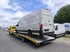 Vier Autotransporter der Hess Fahrzeuglogistik mit geladenen Fahrzeugen auf einem Parkplatz.