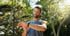 Smiling man in a tank top checks his smartwatch after jogging