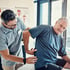 Older man’s lower back assessed by a physical therapist for pain