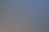 Eine Reihe von Holzliegen mit Handtüchern auf einer Terrasse mit Meerblick und einem Gebäude mit dem Schriftzug "AMOR".