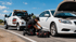 Towing Corona roadside assistance technician diagnosing a disabled car with the hood open on the roadside.