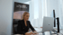 Blonde woman in black blazer working on a MacBook in a modern office with a "Real Estate Blondies" banner.