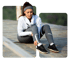 Woman in workout gear holding ankle, showing foot and ankle pain