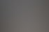 Vier Männer prüfen technische Zeichnungen auf einem Tisch in einem Büro.