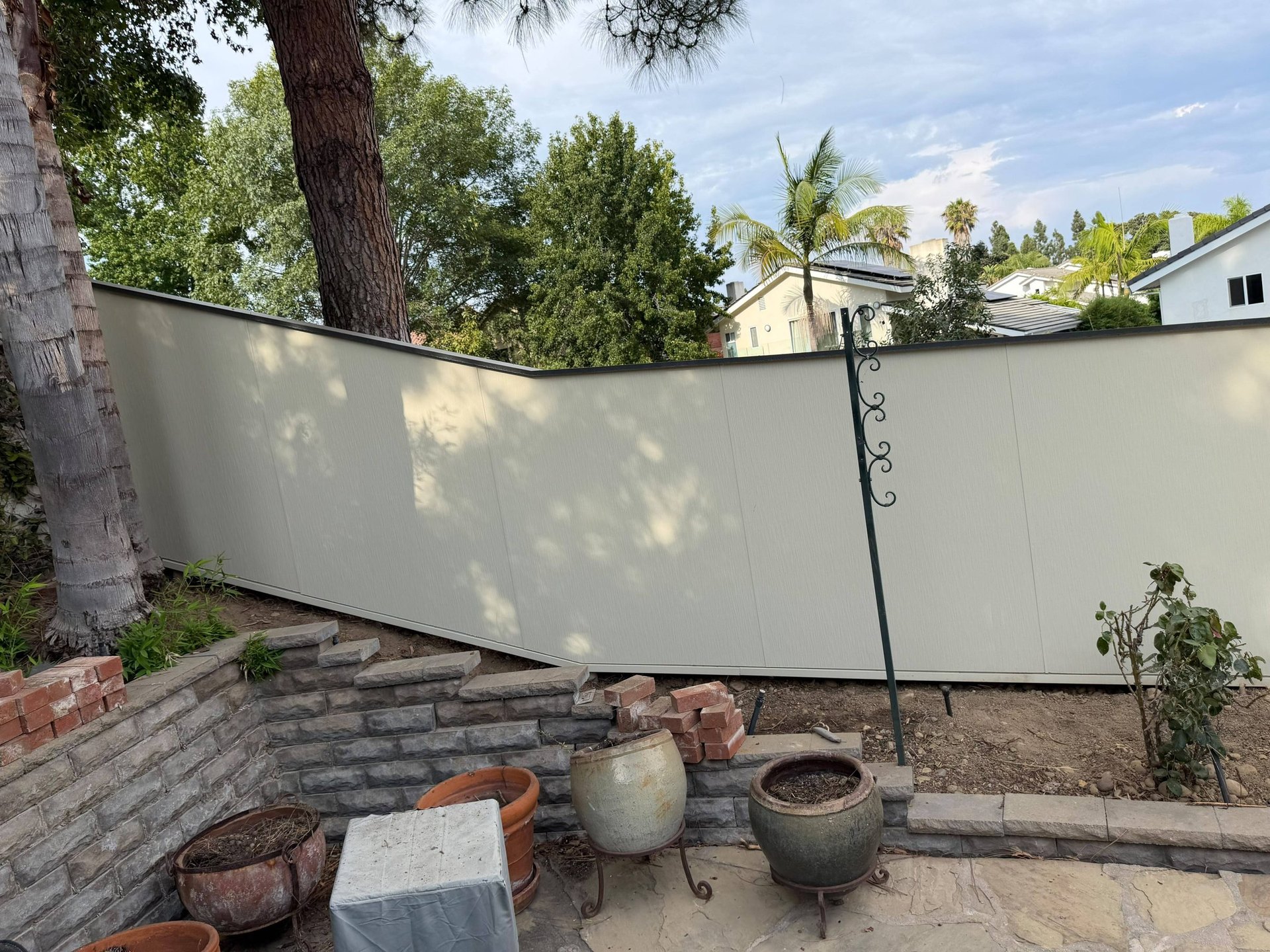 Hardie panel fence behind a garden terrace at a San Diego home