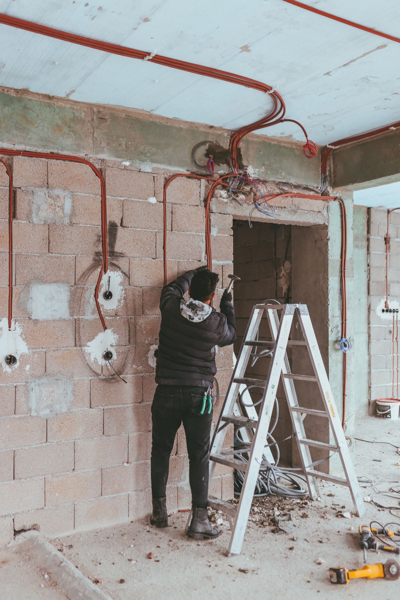 Electrician installing an EV charger on a garage wall