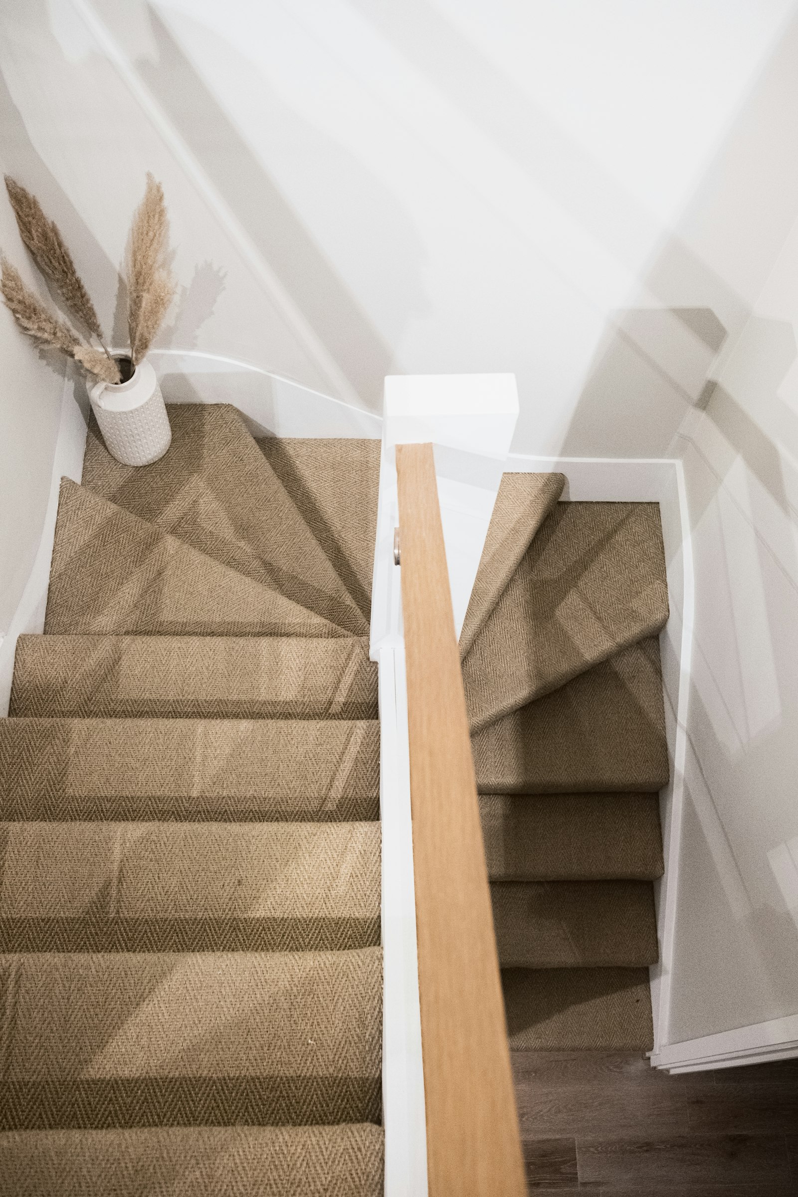 Finished wooden staircase treads and risers in a two-level home