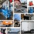 Blauer Hubsteiger, Anhänger mit OBI-Plane, weißer Transporter, Tischkicker, zwei geschlossene Anhänger und Stehtische.