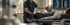 A clinician adjusts a spinal decompression machine for a patient lying on a treatment table near X-ray monitors.