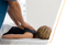 Chiropractor adjusting a child's upper back and neck on a white examination table.