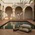 Yoga mat and linen cushions beside a calm riad -60ec7f28-49a8-47a1-8ebd-374cb05df766.png