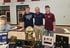Sports medicine setting with athletes and a trophy display on table
