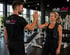 Mann und Frau geben sich im Fitnessstudio High-Five; "club vital Fitness & Gesundheit" Logo.
