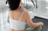Woman holding shoulder, showing rotator cuff pain and treatment focus.