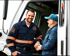 Towing Corona technician assisting a customer beside a tow truck during emergency roadside service.