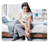 Young woman in bed holding ankle, experiencing neuropathy pain