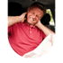 A man in a red polo shirt grimaces and holds his neck in a car after an airbag deployment.