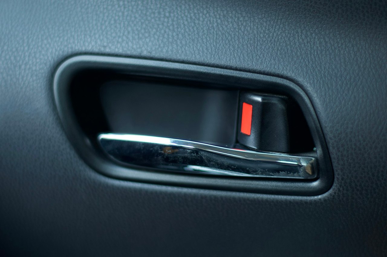 Interior car door handle with the lock tab down, the view after locking keys in the car in Hanford, California