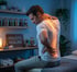 Man with an illuminated spine overlay highlighting areas needing holistic medicine treatment.
