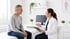 Pain control clinic doctor consults smiling male patient in office