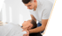 Chiropractor adjusting a woman's neck as she lies on her back.