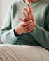 Elderly patient experiencing nerve pain in hands and fingers