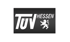 TÜV Hessen Logo in Weiß auf schwarzem Hintergrund mit stilisiertem hessischen Löwen.