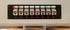 Schwarzes Patchpanel mit 8 nummerierten RJ45-Ports, roten, orangen und grünen Status-LEDs.