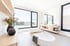Modernes Badezimmer mit ovaler Badewanne, Holzregalen, großen Fenstern und einem Spiegel über dem Waschbecken.