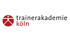 Logo der Trainerakademie Köln mit stilisierter roter Person und schwarzem Text "trainerakademie köln".