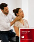 Male chiropractor adjusts a female patient's jaw for TMJ treatment.