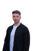 Ein junger Mann mit dunklem, lockigem Haar, einem Bart und einer schwarzen Strickjacke über einem weißen T-Shirt blickt nach vorne.