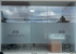 Glass doors of "JDH Design and Build" office with frosted lower panels showing company logo and text.