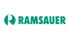 Grünes Logo der Firma Ramsauer mit dem Buchstaben R in einem Kreis auf schwarzem Hintergrund.