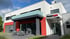 Modernes Bürogebäude mit weißer und roter Fassade, Mastercam-Logo am Eingang, Terrasse mit Möbeln.