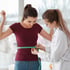 A clinician measures a patient’s waist during a medical weight loss checkup.