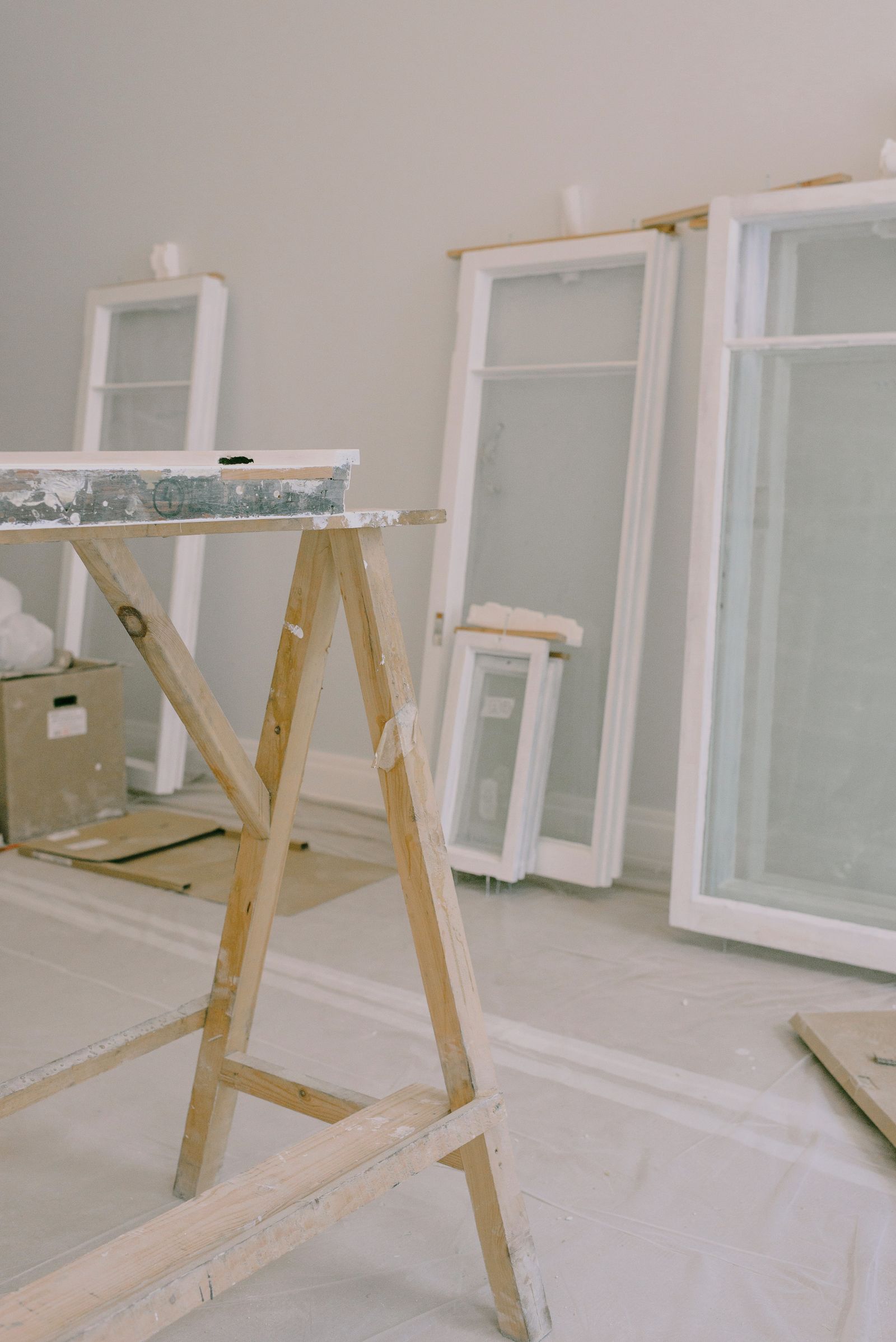 Replacement window units staged in a room prepared for full-frame installation