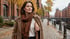 Frau im Herbstmantel mit kleinem Pflaster am Oberarm in der Hamburger Speicherstadt (KI generiertes Bild)