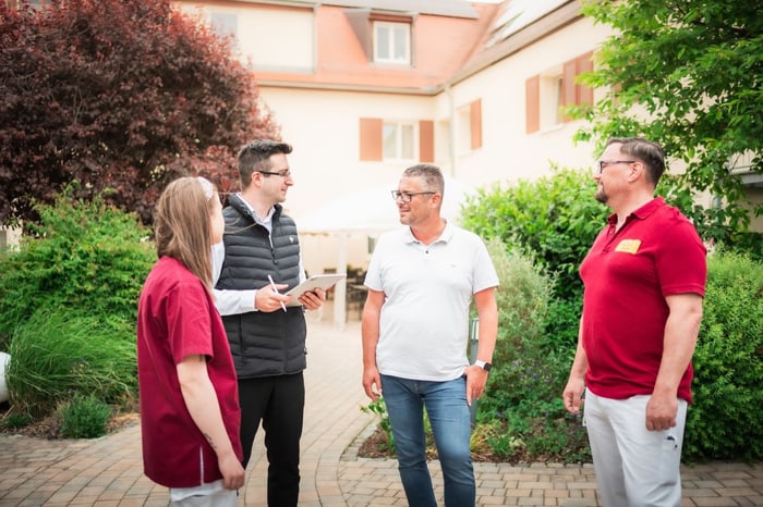 Christian Wolfram im Gespräch mit einem Pflegeteam