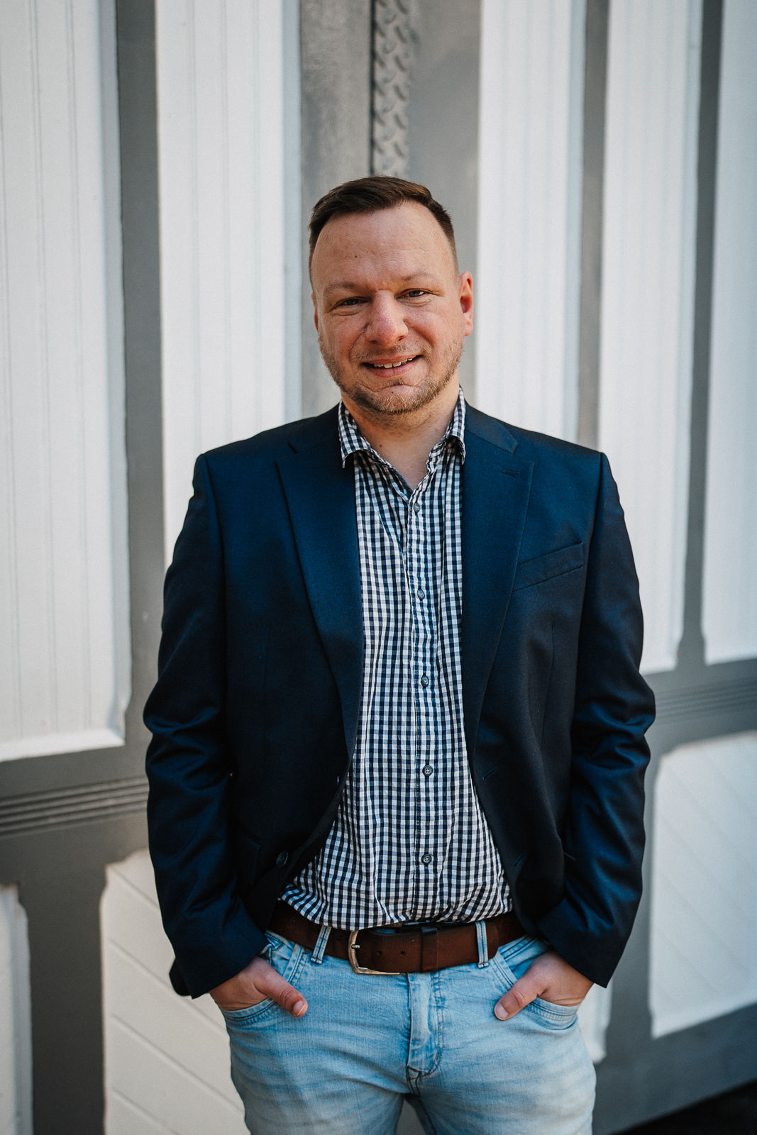 Matthias vor einer hellen Flensburger Fassade