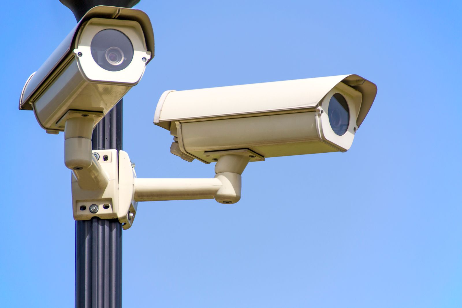 An exterior security camera mounted on a residential wall