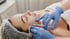 Woman receiving cosmetic facial injection treatment