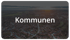 Luftaufnahme einer Wohnsiedlung mit dem weißen Schriftzug „Kommunen“ im Vordergrund.