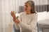A mature woman with arthritis holding her painful wrist.
