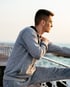 Man stretching outdoors with shoulder pain from pinched nerve relief