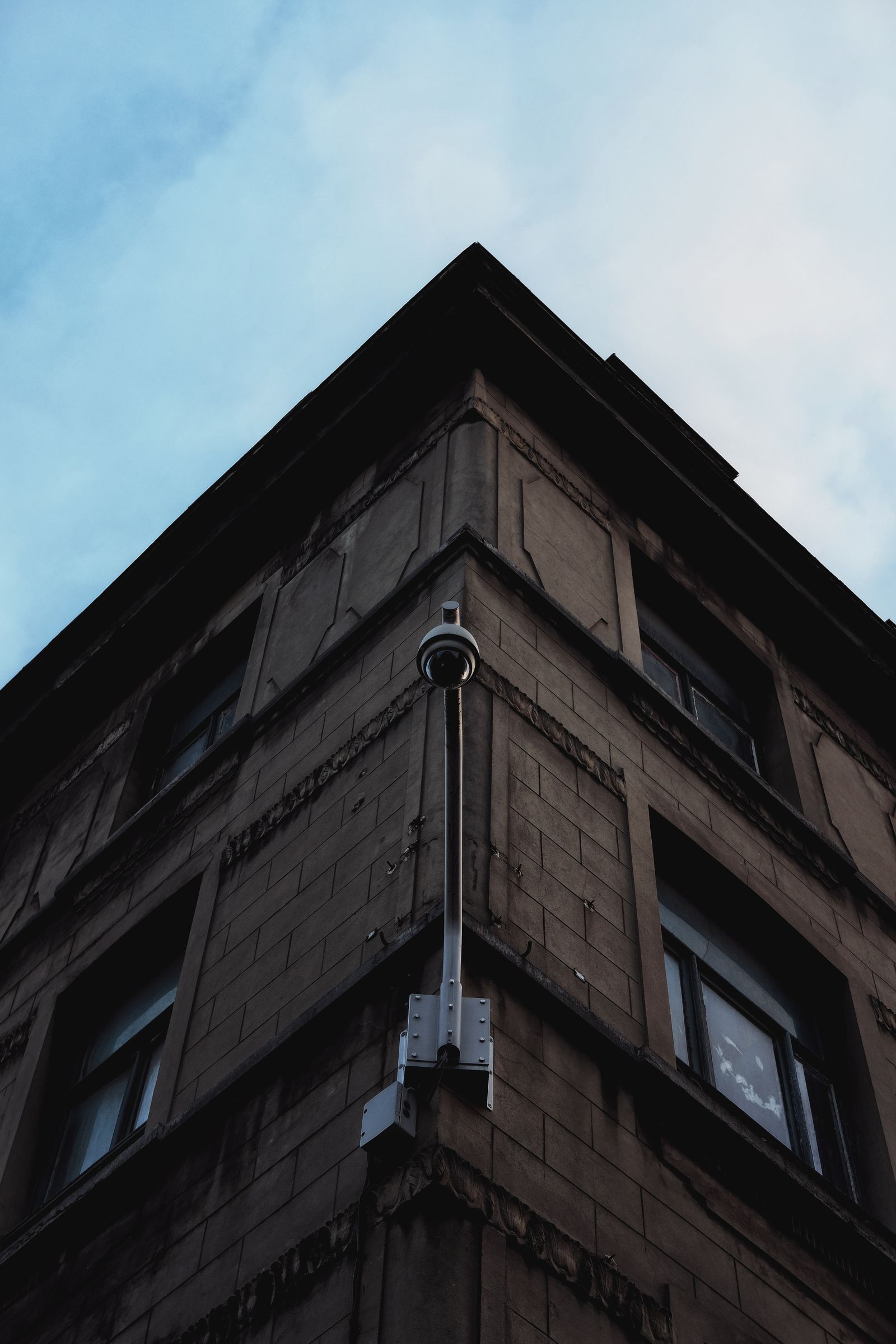 A home security camera mounted under a roofline