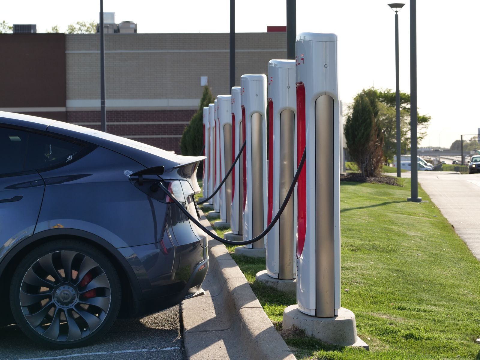 Row of electric vehicle charging stations in a parking lot