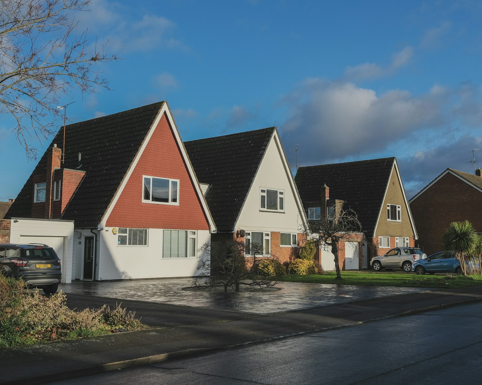 Storm-damaged shingles and displaced roofing on a residential slope